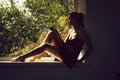 Pretty girl on window sill Royalty Free Stock Photo