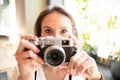 Young girl with pretty eyes holding a vintage camera in her hands Royalty Free Stock Photo