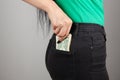 young girl pulls money out of her back pocket Royalty Free Stock Photo