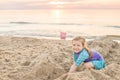 Young girl splashing and throwing ball in lake