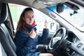 A young girl puts on a protective mask in the car