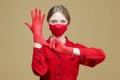 Young girl puts on red gloves and a face mask. Concept for preventing coronavirus covid 19 Royalty Free Stock Photo