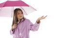 Young girl in a raincoat and holding an umbrella