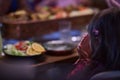 A young girl raises her hands in prayer as she prepares for her iftar meal during the holy month of Ramadan, embodying Royalty Free Stock Photo