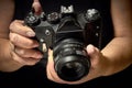 A young girl raises the shutter on her camera to take a photo, holding an antique film camera in her hands. Royalty Free Stock Photo