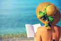 Young girl, reading a book at the beach Royalty Free Stock Photo