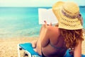 Young girl, reading a book at the beach Royalty Free Stock Photo