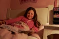 Young Girl Reading Book In Bed At Night Royalty Free Stock Photo