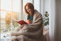 Young girl reading book and drinking morning coffee at home Royalty Free Stock Photo