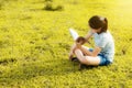 Young girl reading a book in gold meadow contryside nature Royalty Free Stock Photo