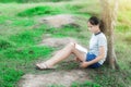 Young girl reading a book in green meadow contryside nature Royalty Free Stock Photo