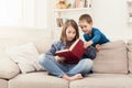 Young girl reading book for her brother Royalty Free Stock Photo