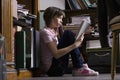 Young Girl Reading Book In Library Royalty Free Stock Photo