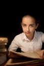 Young girl reading book at night dark at library Royalty Free Stock Photo