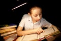 Young girl reading book at night dark at library Royalty Free Stock Photo