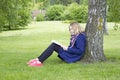 Young girl reading book in park Royalty Free Stock Photo