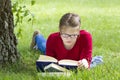 Young girl reading book in park Royalty Free Stock Photo
