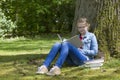 Young girl reading book in park Royalty Free Stock Photo