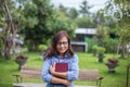 Beautiful girl reading books in the garden