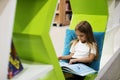 Young Girl Reading Children Story Book in Library Royalty Free Stock Photo