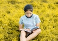 Young girl reading in gold meadow contryside nature in evening l Royalty Free Stock Photo