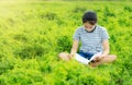 Young girl reading in green meadow contryside nature Royalty Free Stock Photo