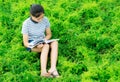Young girl reading in green meadow contryside nature in evening Royalty Free Stock Photo
