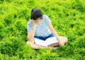 Young girl reading in green meadow contryside nature Royalty Free Stock Photo