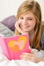 Young girl reading her journal of memories