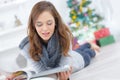 Young girl reading while laying on floor Royalty Free Stock Photo