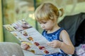 Young girl reading menu