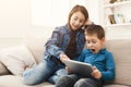 Young girl reading tablet for her brother Royalty Free Stock Photo