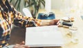 Young girl reads book during breakfast and coffee, female hands close up flipping through magazine pages in home relax atmosphere