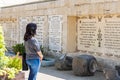 A young girl reads a line from the Gospel of Mark, written on a wall in the Baptismal place of Yadenit, where baptismal rites are