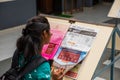A young girl reads the newspaper in the college Royalty Free Stock Photo