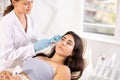 Young girl receiving facial procedure with hydrogen and oxygen ions attachment