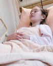 Young tween girl in hospital bed Royalty Free Stock Photo