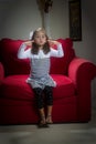 Young girl of red couch vertical