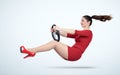 Young girl in a red dress with a car steering wheel