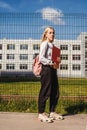 Young girl near school fence Royalty Free Stock Photo