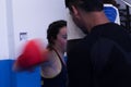 Movement puch of young girl training boxing in a gym with her trainer Royalty Free Stock Photo