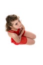 Young girl in red leotard kneeling Royalty Free Stock Photo