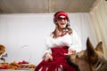 Young girl in red scarf, large headphones with microphone and black glasses and big shepherd dog. Woman who is radio or Royalty Free Stock Photo