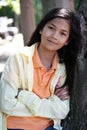 Young girl relaxing against tree Royalty Free Stock Photo