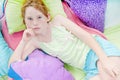 Young girl relaxing on cushions Royalty Free Stock Photo