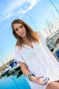 Young girl relaxing while earing music at the dock