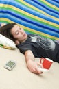 Young Girl Relaxing With Remote Control Angled Royalty Free Stock Photo