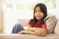 Young Girl Relaxing On Sofa At Home Royalty Free Stock Photo