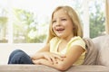 Young Girl Relaxing On Sofa At Home Royalty Free Stock Photo