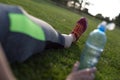 Young girl is resting on grass after training, running concept Royalty Free Stock Photo